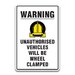 WARNING UNAUTHORISED VEHICLES WILL BE WHEEL CLAMPED SIGN